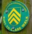 Bury to Clare Walk green and yellow waymarker disc on wooden post