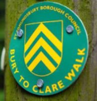 Bury to Clare Walk green and yellow waymarker disc on wooden post