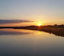 a golden and purple sunset reflected on the River Deben at Cattawade