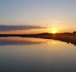 a golden and purple sunset reflected on the River Deben at Cattawade