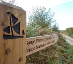Woooden finger post showing the Sailors' Path logo, Snape Warren 2 miles and Snape Maltings 4 miles