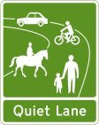 Quiet Lane sign 2 Green and white sign for Quiet Lanes, depicting an adult and child walking together, a person on a horse, a person on a bike, and a car