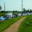various leisure boats moored along side the Waveney river path at Beccles on a sunny day